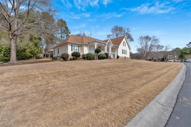 view of front of house featuring a front yard and covered porch