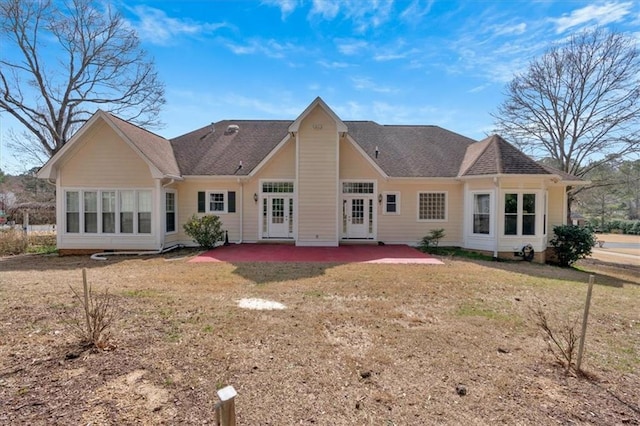 rear view of house featuring a patio area and a lawn