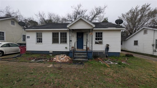 bungalow-style home with a front lawn