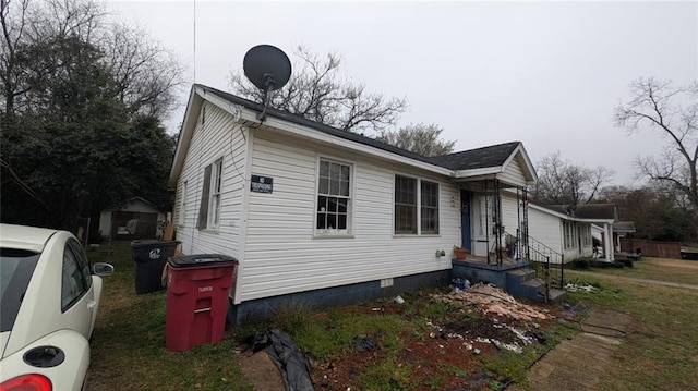 view of side of home with crawl space