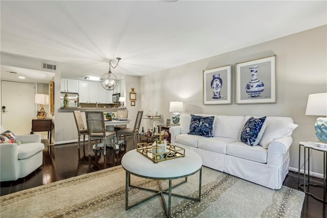 3650 Ashford Dunwoody Rd NE Unit 1024, Atlanta, GA 30319 - living room featuring wood finished floors and a chandelier