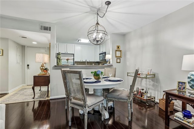 3650 Ashford Dunwoody Rd NE Unit 1024, Atlanta, GA 30319 - dining area featuring a chandelier and dark wood-style floors