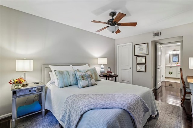 3650 Ashford Dunwoody Rd NE Unit 1024, Atlanta, GA 30319 - bedroom featuring wood finished floors, a ceiling fan, and connected bathroom