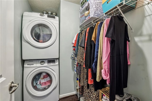 3650 Ashford Dunwoody Rd NE Unit 1024, Atlanta, GA 30319 - laundry area featuring stacked washing machine and dryer and a textured ceiling