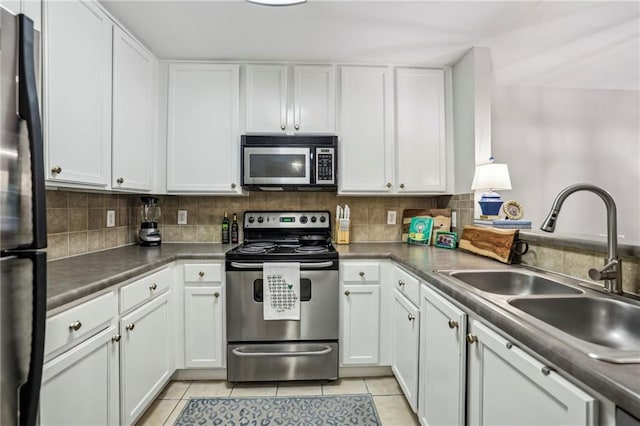 3650 Ashford Dunwoody Rd NE Unit 1024, Atlanta, GA 30319 - kitchen with stainless steel appliances, white cabinetry, light tile patterned floors, and backsplash