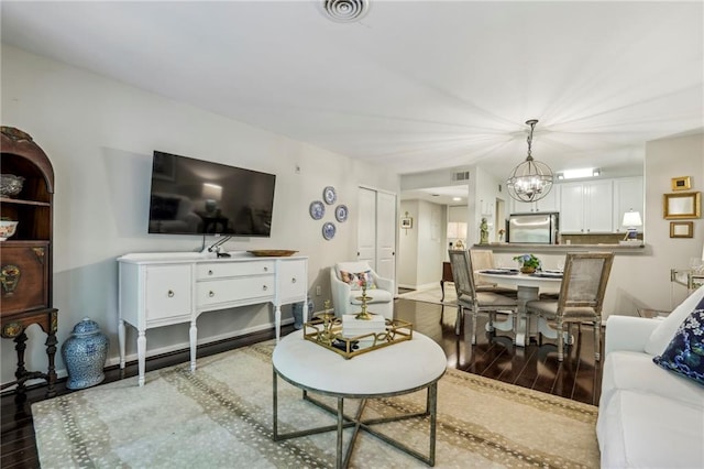 3650 Ashford Dunwoody Rd NE Unit 1024, Atlanta, GA 30319 - living room featuring a chandelier and wood finished floors