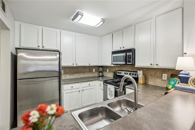 3650 Ashford Dunwoody Rd NE Unit 1024, Atlanta, GA 30319 - kitchen featuring stainless steel appliances, white cabinetry, and decorative backsplash