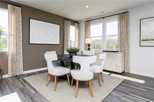 dining room featuring wood finished floors, baseboards, and recessed lighting