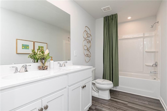 full bath featuring shower / bath combination with curtain, toilet, wood finished floors, and double vanity