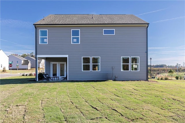 back of property featuring a yard