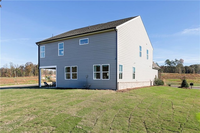back of house featuring a lawn and a patio