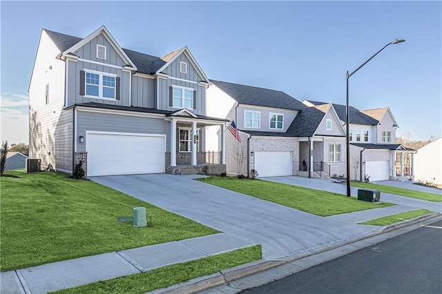 view of front of home featuring an attached garage, board and batten siding, concrete driveway, and a front yard
