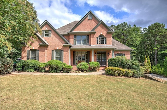 craftsman inspired home featuring a front yard and covered porch