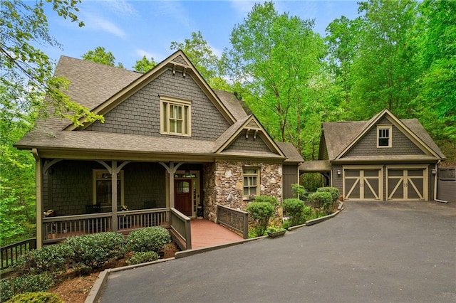 craftsman-style house featuring a porch and a garage