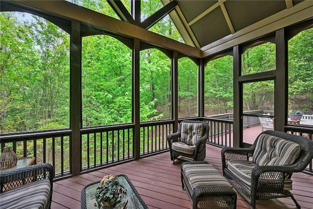 sunroom featuring a wealth of natural light and lofted ceiling