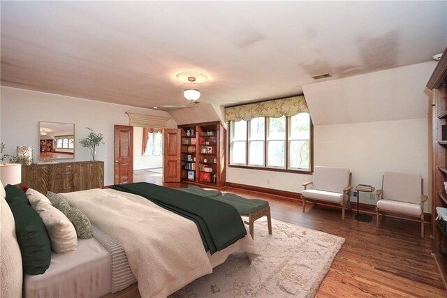 unfurnished living room featuring a wealth of natural light, french doors, hardwood / wood-style floors, and a notable chandelier