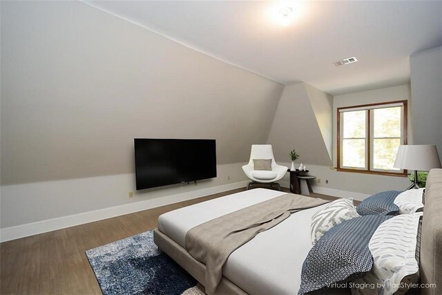 living room with hardwood / wood-style flooring, wooden walls, and an inviting chandelier