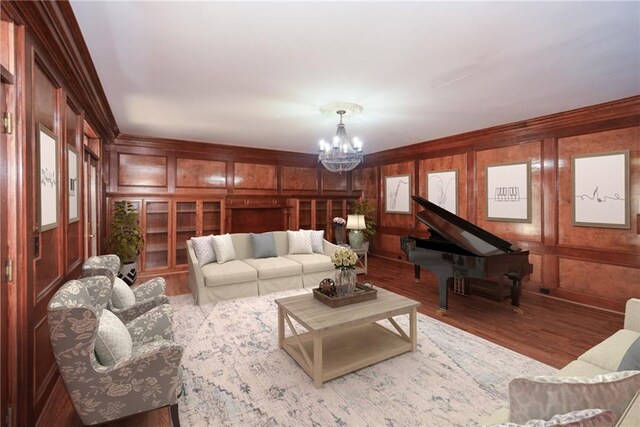 kitchen featuring stainless steel appliances, light hardwood / wood-style flooring, ornamental molding, and an island with sink