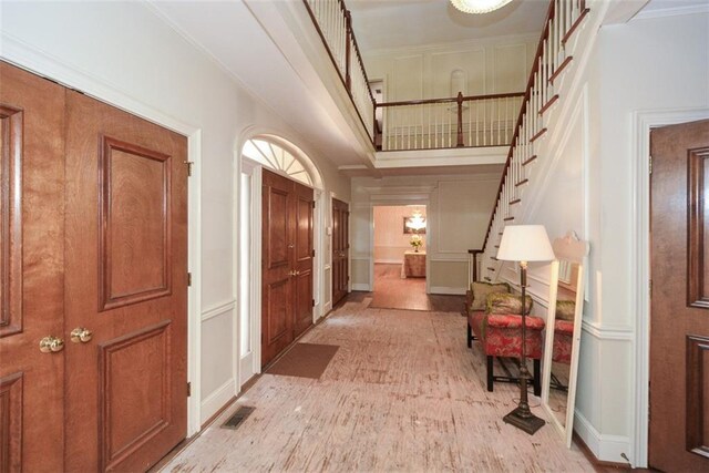 living room with wood-type flooring and ornamental molding