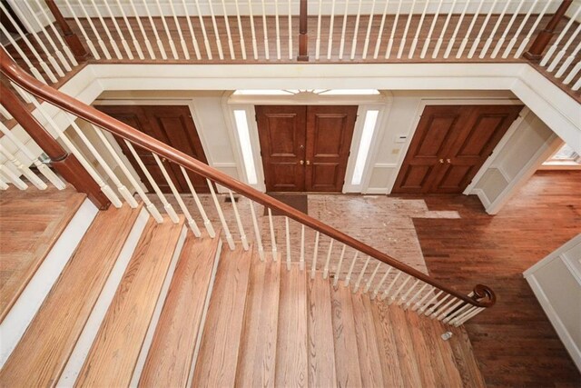 unfurnished living room featuring dark hardwood / wood-style flooring and crown molding