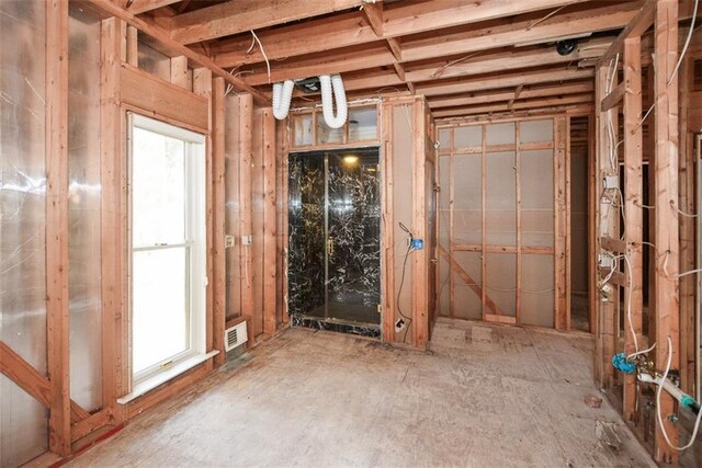 unfurnished living room featuring ceiling fan, wood-type flooring, and ornamental molding