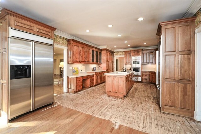 unfurnished living room featuring hardwood / wood-style flooring, plenty of natural light, and built in shelves