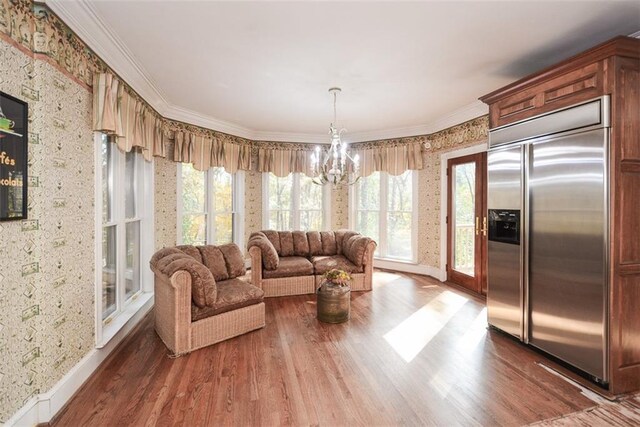 dining space with a healthy amount of sunlight, dark hardwood / wood-style flooring, and a chandelier