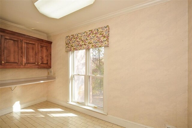 bathroom with tile patterned flooring, vanity, a relaxing tiled tub, and crown molding