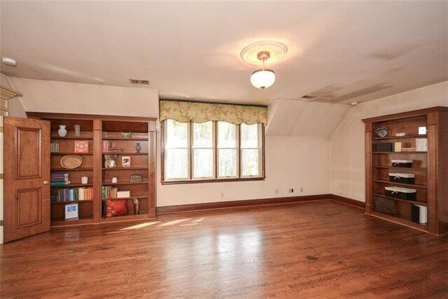 additional living space with carpet flooring, ceiling fan, and vaulted ceiling