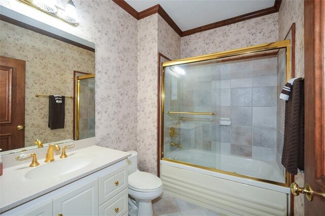 full bathroom featuring vanity, tile patterned floors, crown molding, tiled shower / bath, and toilet