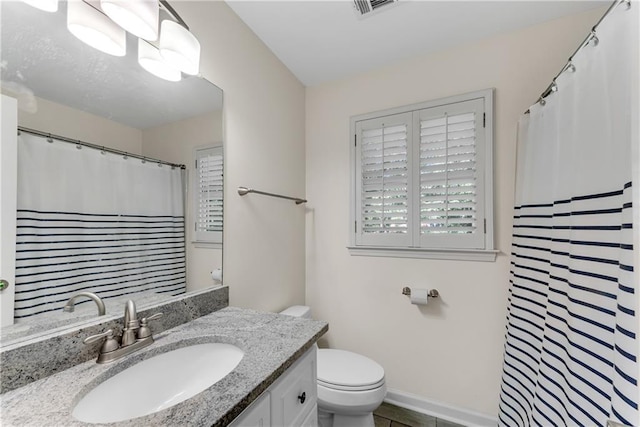 bathroom with toilet and vanity