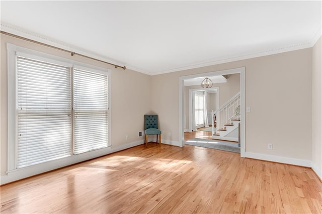 unfurnished room featuring ornamental molding, light hardwood / wood-style flooring, and a notable chandelier