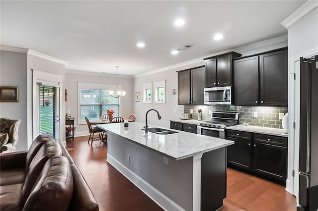 4547 Big Rock Ridge Trl SW, Gainesville, GA 30504 - kitchen with stainless steel appliances, crown molding, wood finished floors, a chandelier, and decorative backsplash