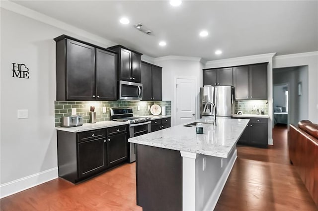 4547 Big Rock Ridge Trl SW, Gainesville, GA 30504 - kitchen featuring stainless steel appliances, crown molding, tasteful backsplash, a center island with sink, and recessed lighting