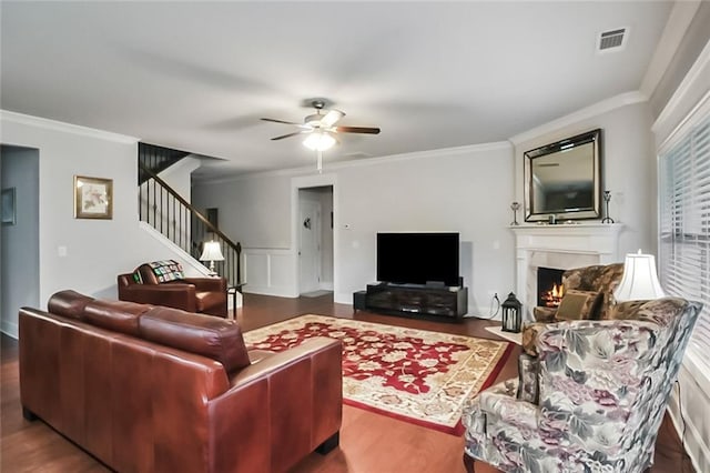 4547 Big Rock Ridge Trl SW, Gainesville, GA 30504 - living room featuring ceiling fan, crown molding, a warm lit fireplace, wood finished floors, and stairs