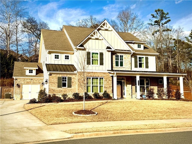 view of front of house featuring board and batten siding, brick siding, a porch, and concrete driveway