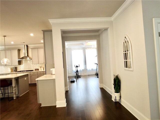 hallway featuring recessed lighting, dark wood-style flooring, baseboards, and ornamental molding