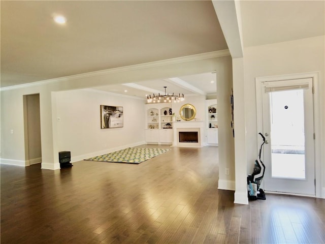 living room featuring crown molding, wood finished floors, a fireplace, and baseboards