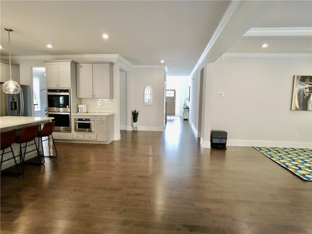 kitchen with dark wood-type flooring, light countertops, and stainless steel appliances