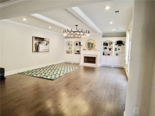 unfurnished living room featuring wood finished floors, a notable chandelier, and ornamental molding