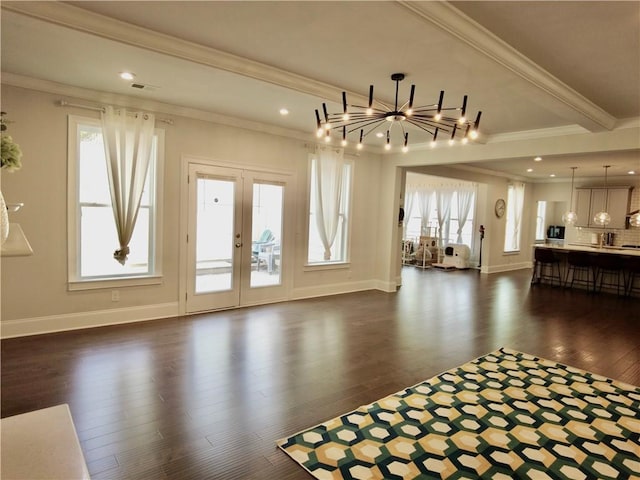 unfurnished living room featuring crown molding, french doors, dark wood-style flooring, and baseboards