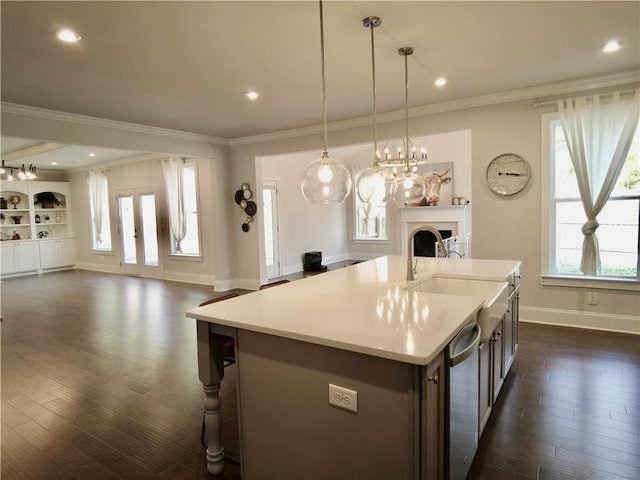 kitchen featuring open floor plan, a fireplace, dishwasher, and dark wood-style floors
