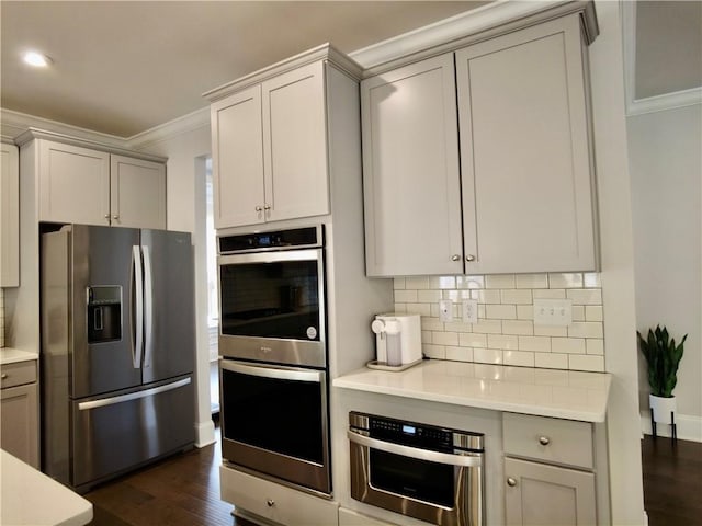 kitchen featuring gray cabinets, crown molding, and appliances with stainless steel finishes