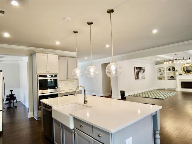 kitchen featuring gray cabinets, appliances with stainless steel finishes, and light countertops