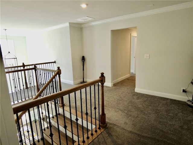 interior space with carpet flooring, visible vents, baseboards, and crown molding