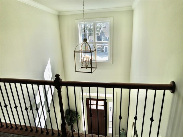 interior space with crown molding and an inviting chandelier
