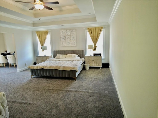 bedroom featuring crown molding, a tray ceiling, baseboards, and carpet