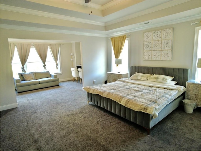 carpeted bedroom featuring a tray ceiling, baseboards, ornamental molding, and visible vents