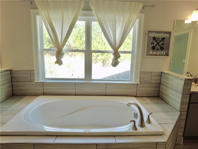 bathroom featuring vanity and a garden tub