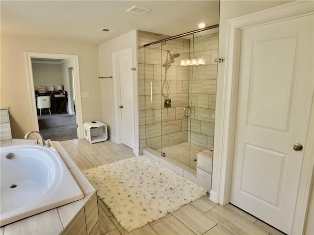bathroom featuring a shower stall, a garden tub, visible vents, and wood tiled floor